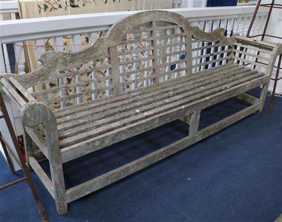 A Lutyens style teak garden bench, W.260cm